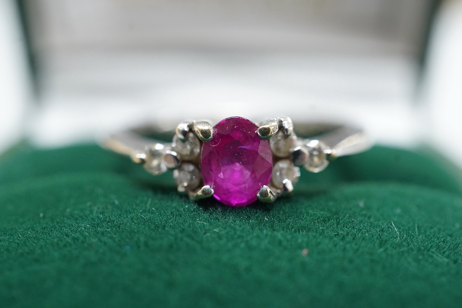 A cased late Victorian 9ct and single stone amethyst set bar brooch, 45mm, a cased yellow metal and single stone white opal set stick pin and a modern 18ct white gold, ruby and diamond cluster ring, size L/M.